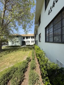 Exterior Acclaim at Baldwin Village Residential building, Meticulous landscaping, white buildings, bushes around the perimeter of the building.